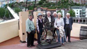 Group next to ships bell at the SS Great Britain
