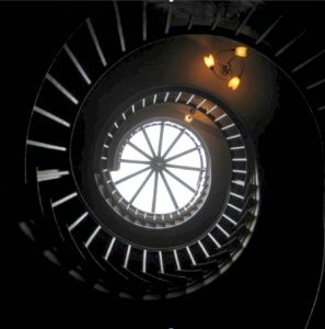 View of a spiral staircase taken from the bottom looking up